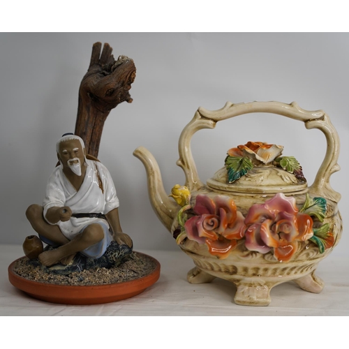 376 - An Oriental style figure and a Capodimonte style teapot.