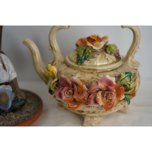 376 - An Oriental style figure and a Capodimonte style teapot.