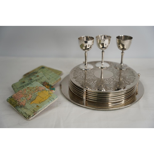 378 - A vintage plated placemat set, eggcups and four map of the world coasters