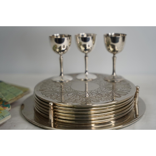 378 - A vintage plated placemat set, eggcups and four map of the world coasters