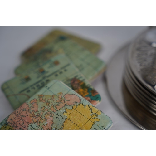 378 - A vintage plated placemat set, eggcups and four map of the world coasters