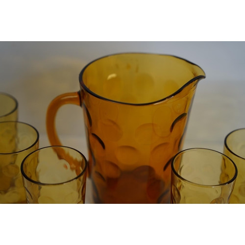 383 - A vintage amber glass drinks set.