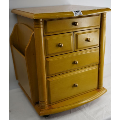 395 - A compact chest of five drawers and magazine racks either side.