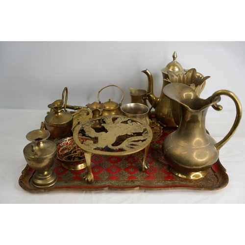 400 - A decorative wood and painted tray and a collection of brass ware.