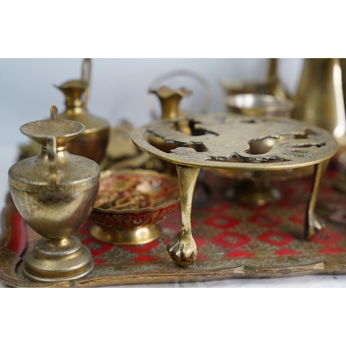 400 - A decorative wood and painted tray and a collection of brass ware.