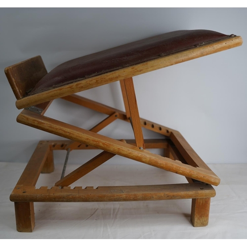 412 - A vintage leather upholstered adjustable footstool.