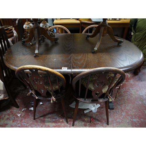 417 - An oak extending dining room table and four chair set.