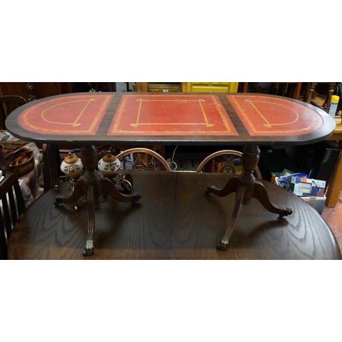 421 - A mahogany double pedestal coffee table with three leather insets.