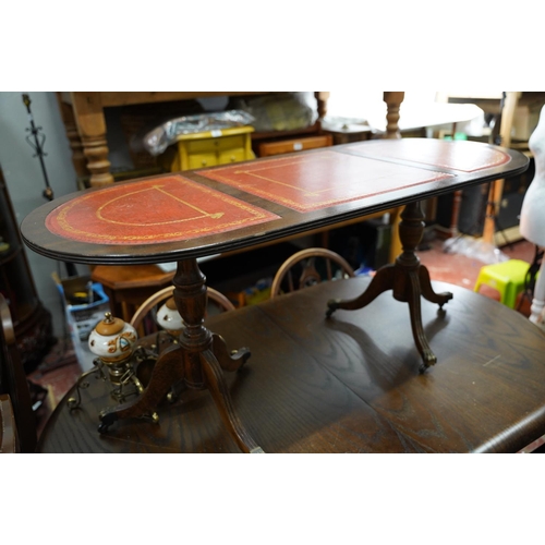 421 - A mahogany double pedestal coffee table with three leather insets.