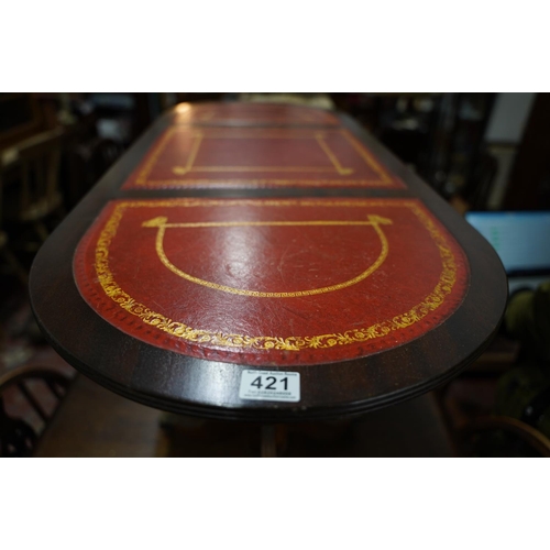 421 - A mahogany double pedestal coffee table with three leather insets.