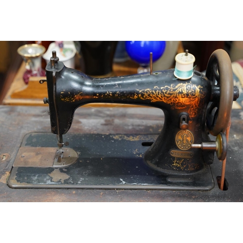 422 - A vintage Singer sewing machine with cast iron base.