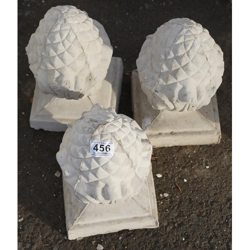 456 - Three concrete acorn pillar toppers.