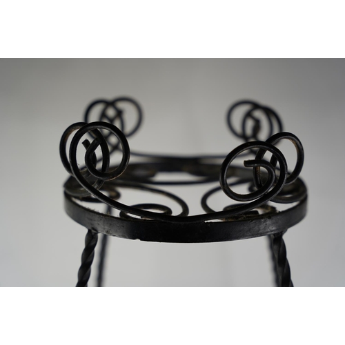 1 - A vintage wrought iron plant stand.