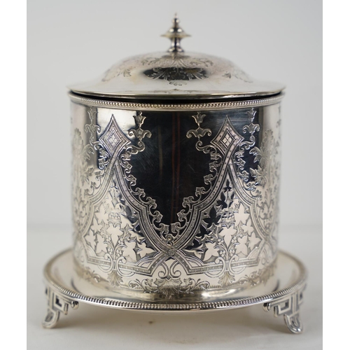 120 - A decorative silver plated biscuit barrel on a footed stand.