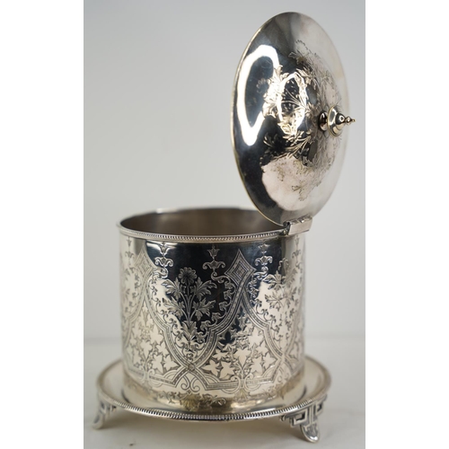 120 - A decorative silver plated biscuit barrel on a footed stand.