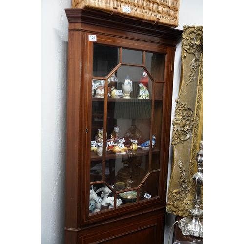 129 - An antique style mahogany and inlaid corner cabinet.