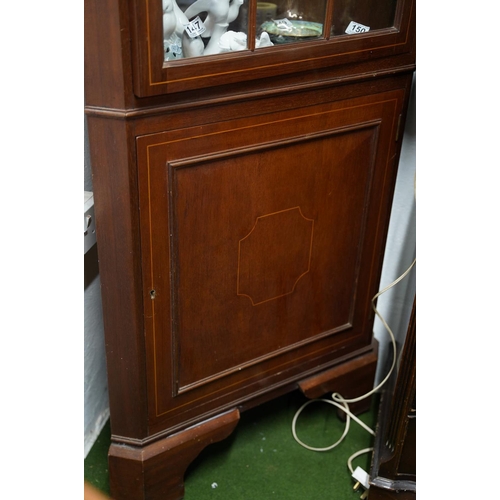 129 - An antique style mahogany and inlaid corner cabinet.