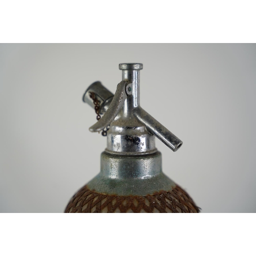 29 - A vintage metal cased soda syphon.