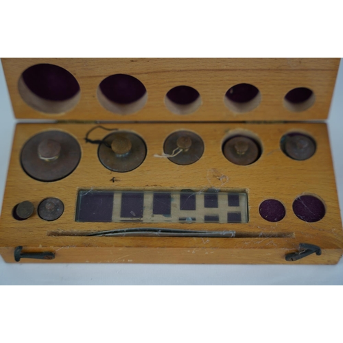 30 - A wood cased set of chemistry weights.