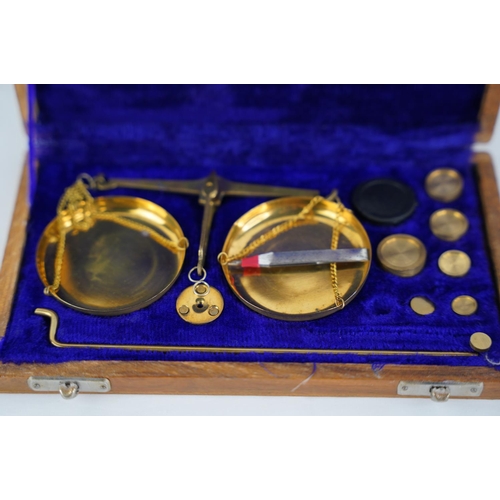 37 - A wood cased set of jewellers scales and weights.