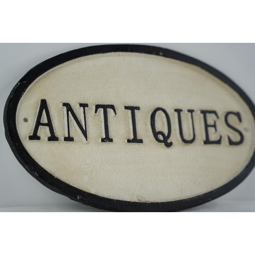 39 - A cast iron 'Antiques' sign.