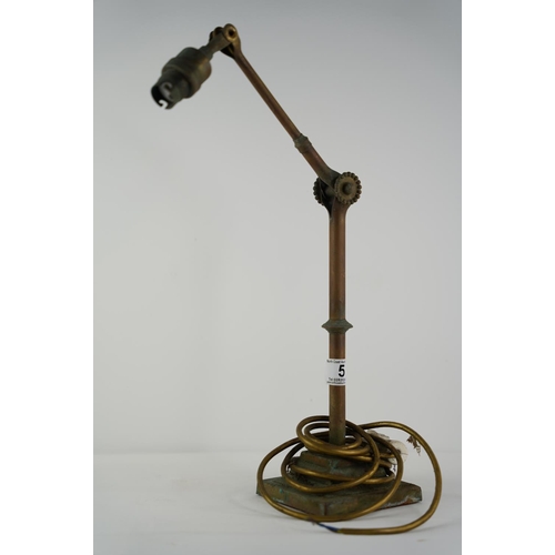 5 - An antique brass angle poise desk lamp.