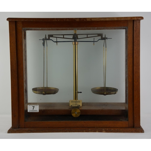 7 - An antique cased set of scales and weights by W B Nicolson, Glasgow.