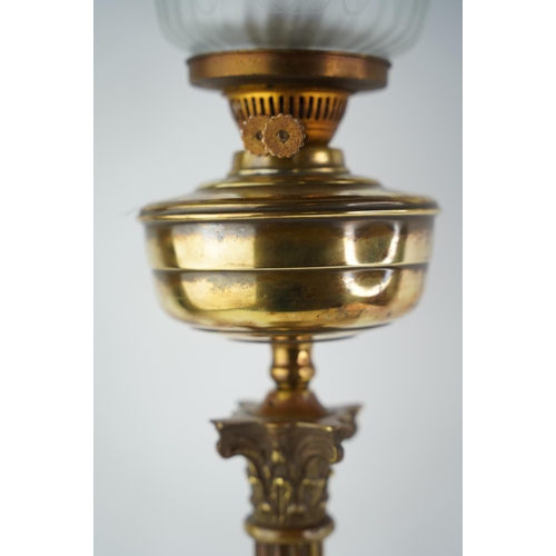 156 - A stunning antique Corinthian based oil lamp with blue glass shade.