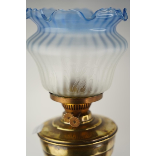 156 - A stunning antique Corinthian based oil lamp with blue glass shade.