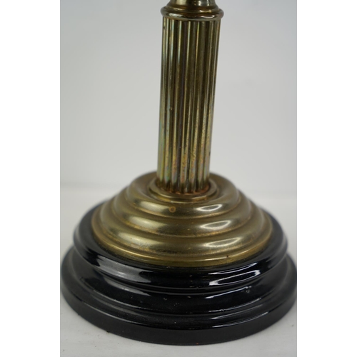 161 - An antique brass font oil lamp with blue striped patterned glass shade.