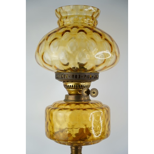 162 - An antique amber glass font oil lamp with amber shade.