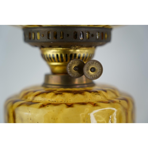 162 - An antique amber glass font oil lamp with amber shade.