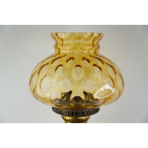 162 - An antique amber glass font oil lamp with amber shade.