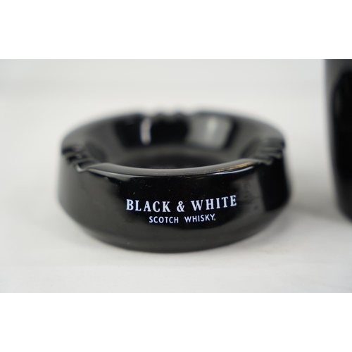 163 - A vintage Wade Black and White Scotch Whisky jug and ashtray.