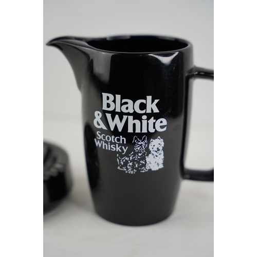 163 - A vintage Wade Black and White Scotch Whisky jug and ashtray.