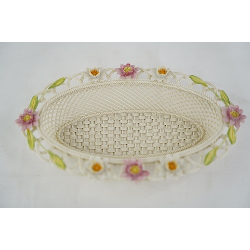 195 - A Belleek pottery limited edition three strand basket 'Lily Blossoms Basket' (a/f).