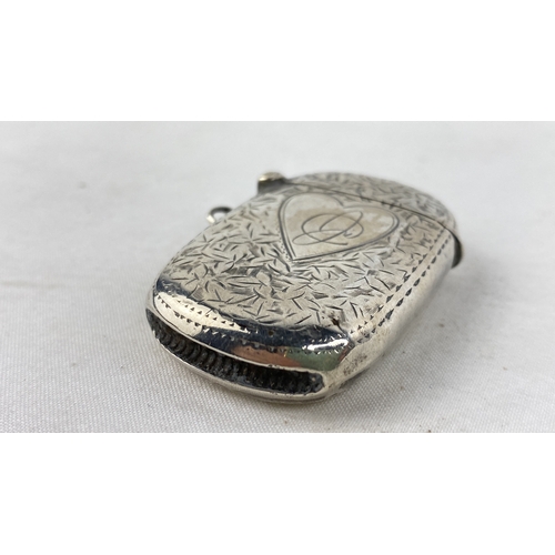 198 - A Sterling silver vesta case with heart design.