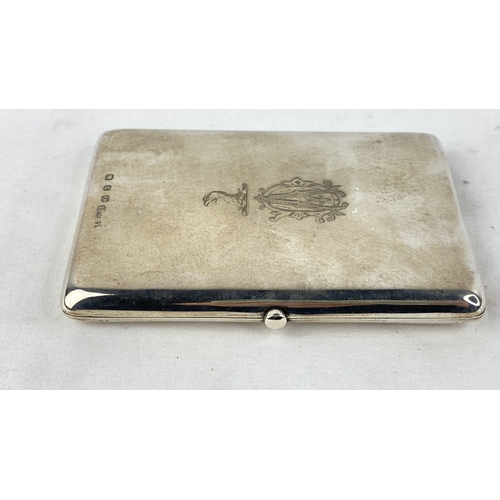 207 - A Sterling silver cigarette case with crested detail, weight 104g.