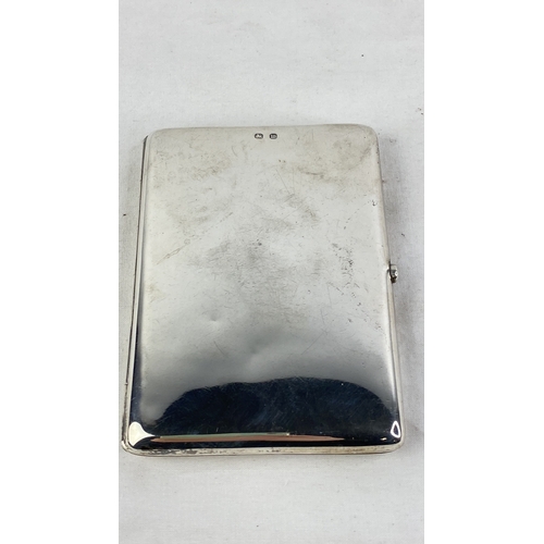 207 - A Sterling silver cigarette case with crested detail, weight 104g.