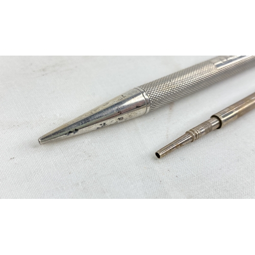 216 - A Sterling silver propelling pen and pencil, total weight 33g.