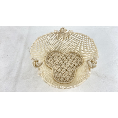 227 - A Belleek pottery four strand basket with rose detail (a/f).