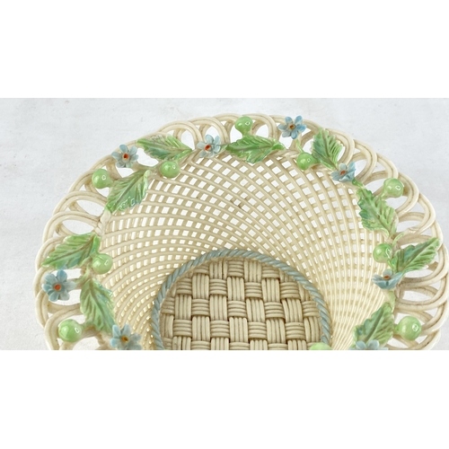 230 - A Belleek pottery four strand floral basket (a/f).