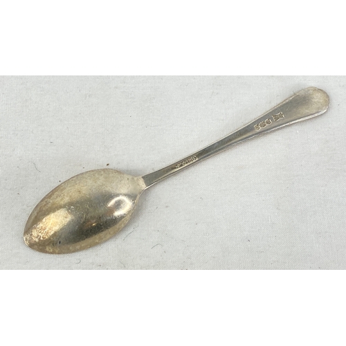 236 - A Sterling silver 'golf' design teaspoon, weight 14g.