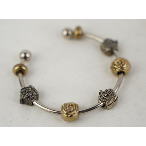 312 - A metal bangle and charms.