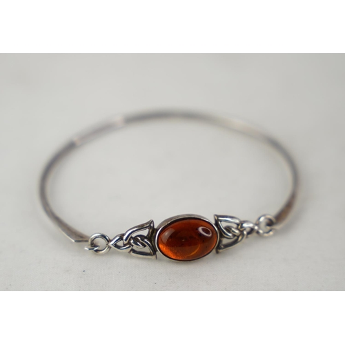 313 - A Sterling silver bangle and gem stone inset.