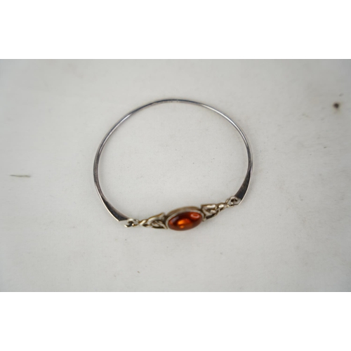 313 - A Sterling silver bangle and gem stone inset.