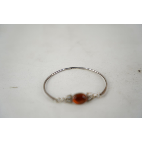 313 - A Sterling silver bangle and gem stone inset.