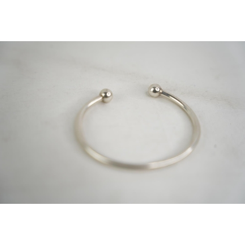 317 - A white metal bangle.