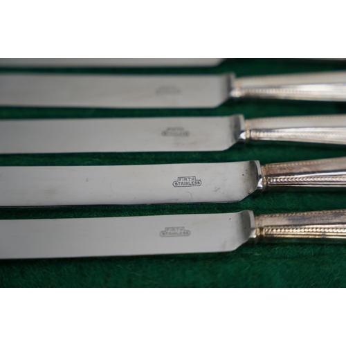 318 - A lot of antique Firth stainless steel knives in a felt sleeve.