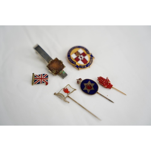 331 - A collection of 6 tie pins & badges.